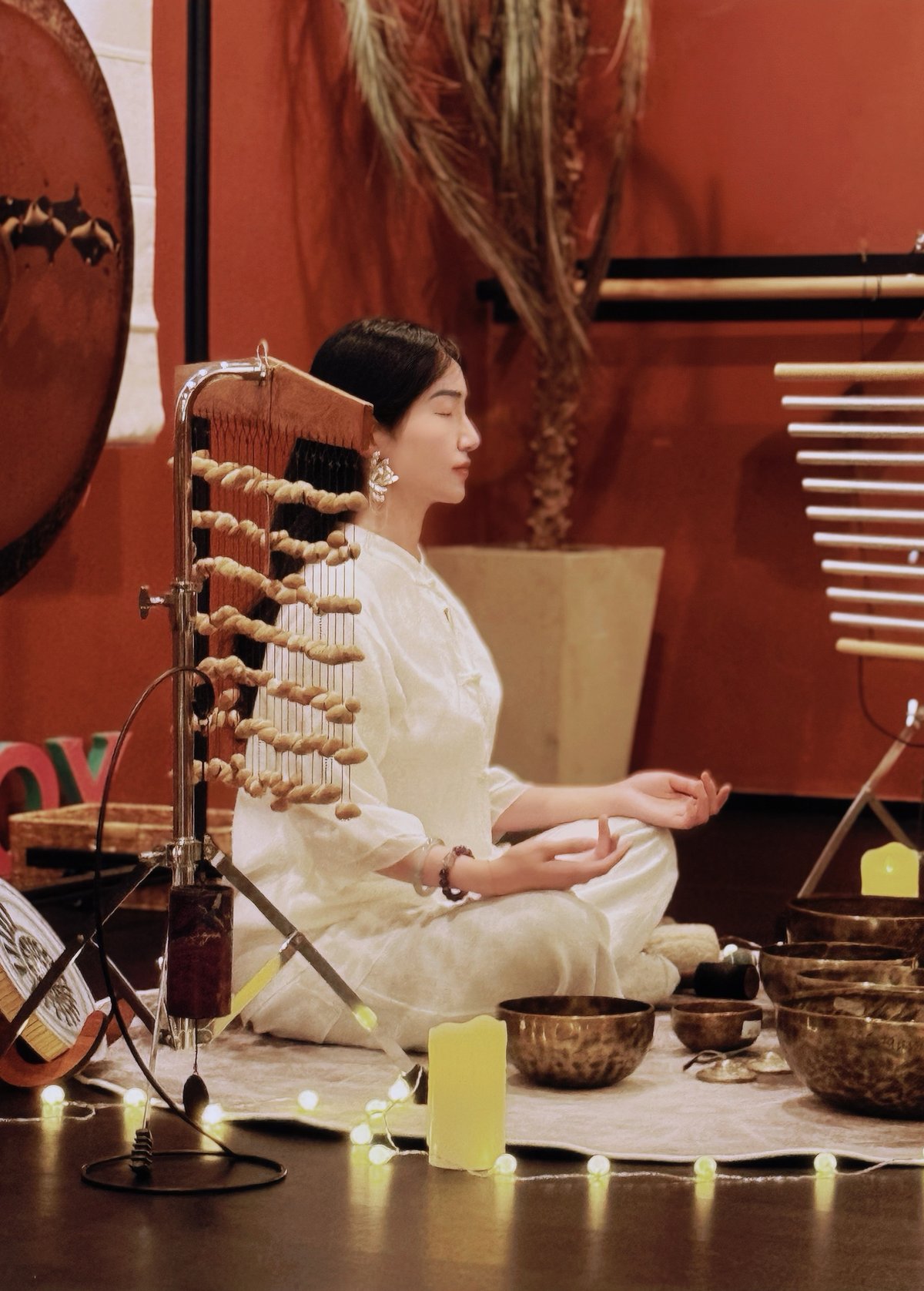 Meditation with singing bowls, candles, and string instrument